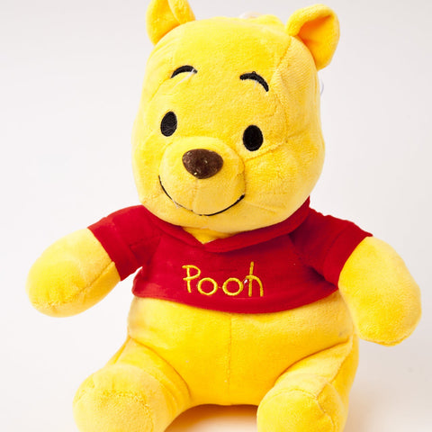 Jucarie de Plus, Winnie the Pooh pufos culoare Galben, cu tricou Rosu, 23cm.